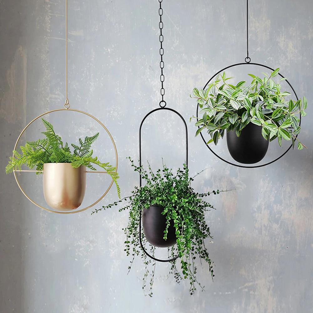 Set of modern hanging metal planters with geometric frames, indoor wall plant holders for home and balcony decor